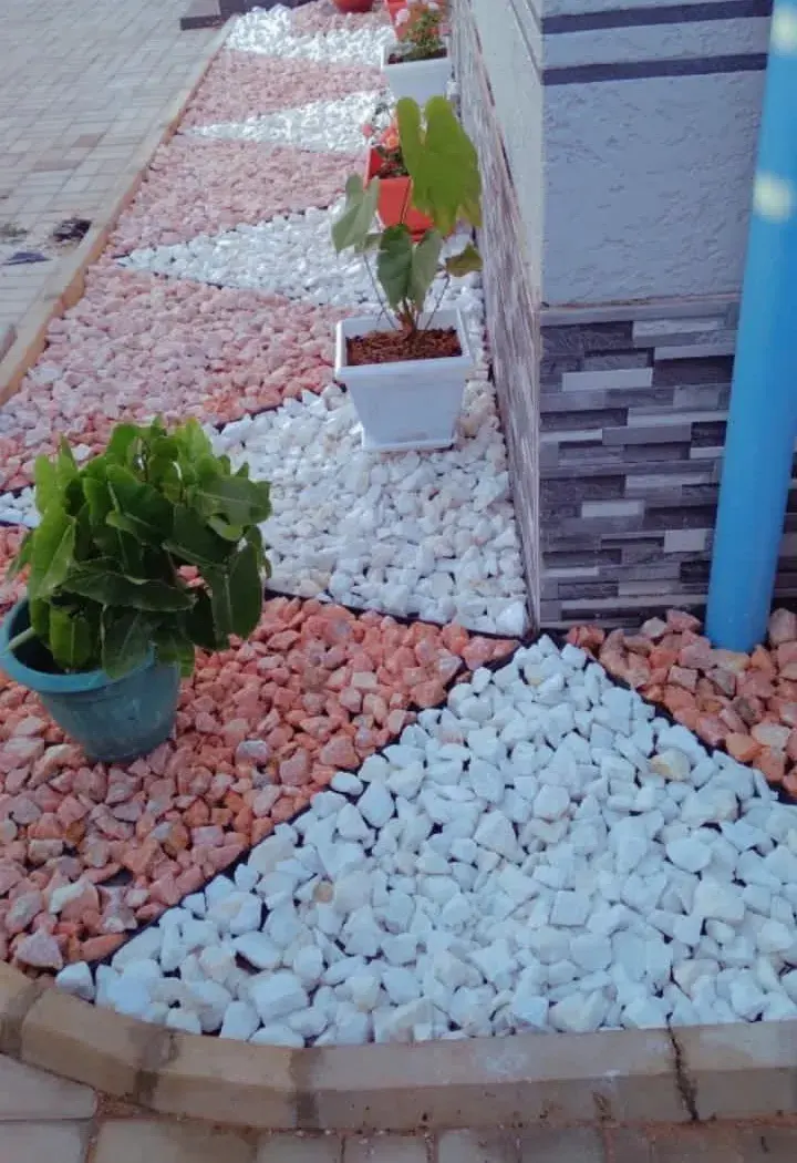 Pink and white decorative stones laid in a pattern