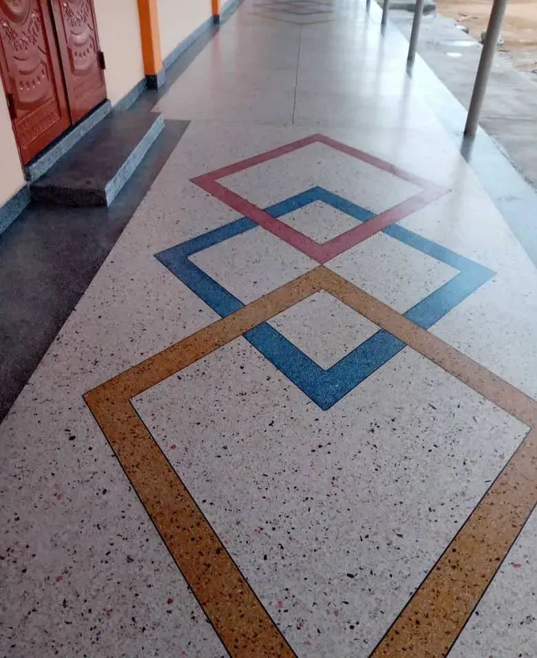 Terrazzo walkway with red, blue and gold diamond inlays