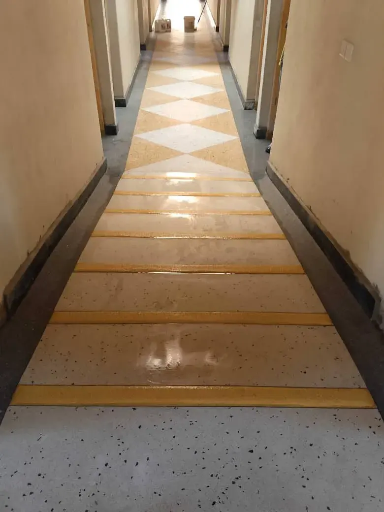 Terrazzo corridor with gold stripes and a diamond pattern