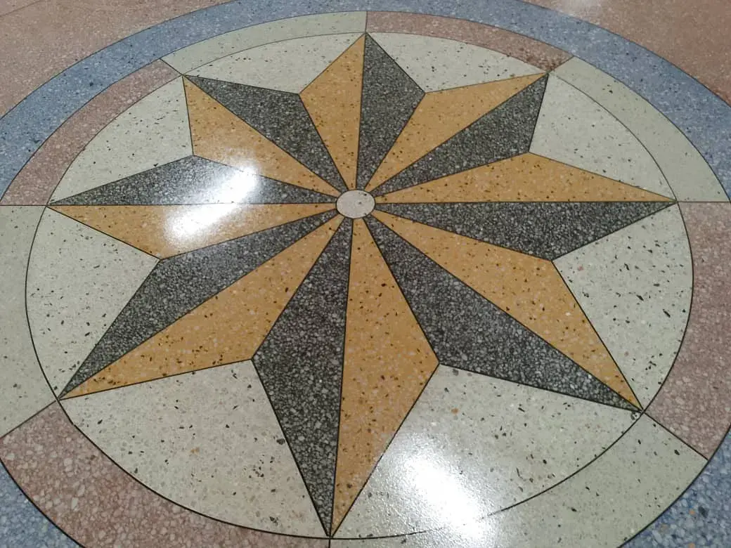 Polished terrazzo floor with an inlaid compass-star pattern
