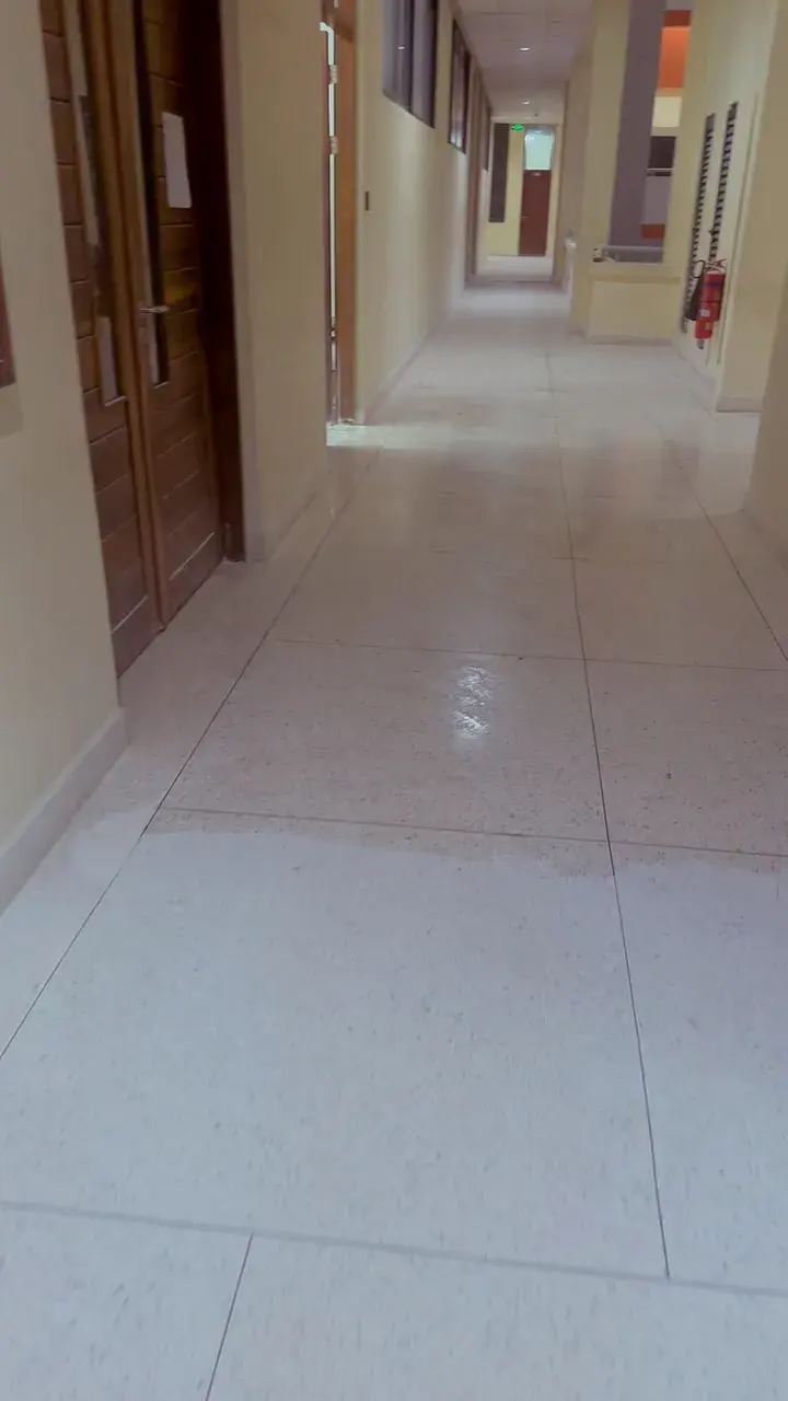 Polished light terrazzo corridor floor with wooden doors, DIT, Dar es Salaam